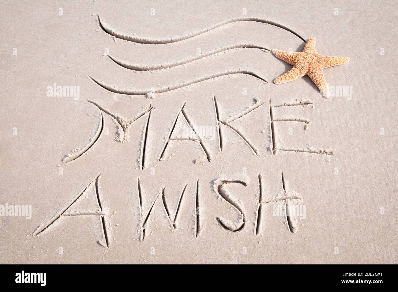 Make A Wish message with shooting starfish in sand Stock Photo Alamy