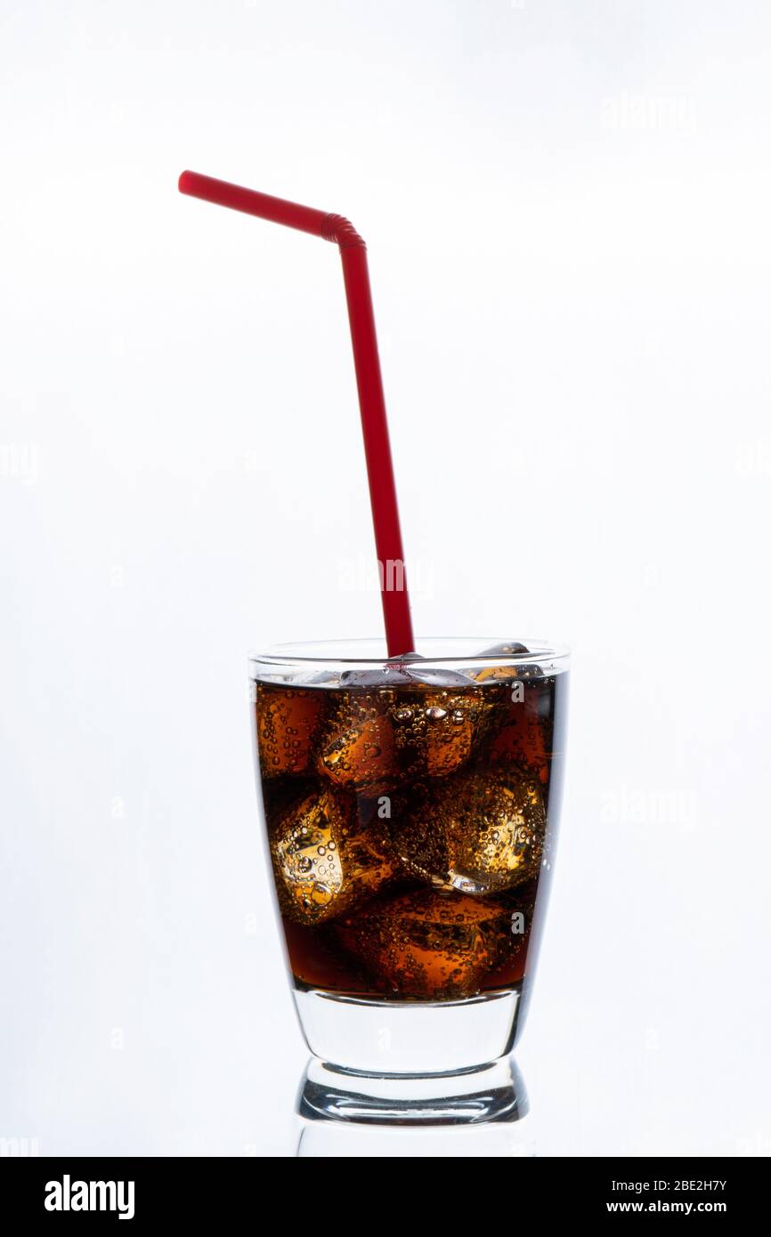 Cold drinking, soda with ice and red   straw, glass of cola for hot and summer drink isolated on white background Stock Photo