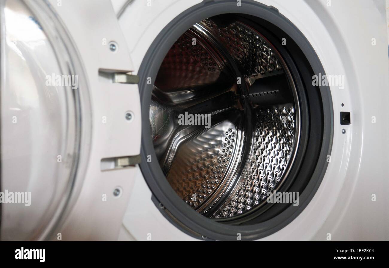 Empty open washing machine drum Stock Photo - Alamy