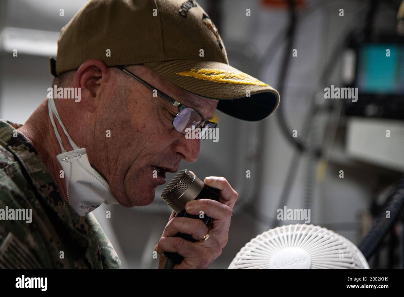 Apra Harbor, Guam. 11th Apr, 2020. U.S. Navy Vice Adm. William Merz, commander, U.S. 7th Fleet, delivers a speech to the crew of the aircraft carrier USS Theodore Roosevelt (CVN 71) on April 7, 2020. Merz arrived in Guam to asses and support the ongoing COVID-19 recovery efforts for the crew of Theodore Roosevelt. Theodore Roosevelt is in Guam for a scheduled port visit for resupply and crew rest during their scheduled deployment to the Indo-Pacific. Photo by MC3 Brandon Richardson/U.S. Navy/UPI Credit: UPI/Alamy Live News Stock Photo