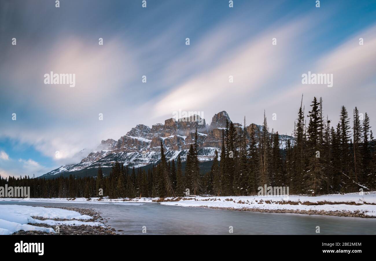 Long exposure of Snow covered Castle Mountain from beside the Bow River at Castle Junction, Banff National Park, Alberta, Canada Stock Photo