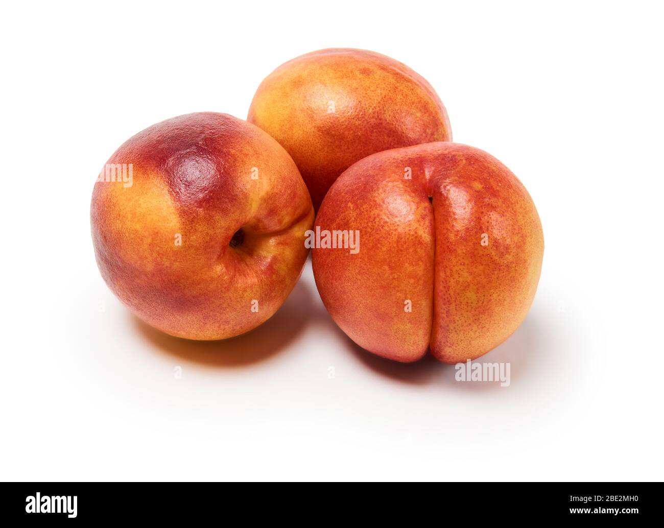 three ripe nectarines on a white background, isolated with a shadow Stock Photo