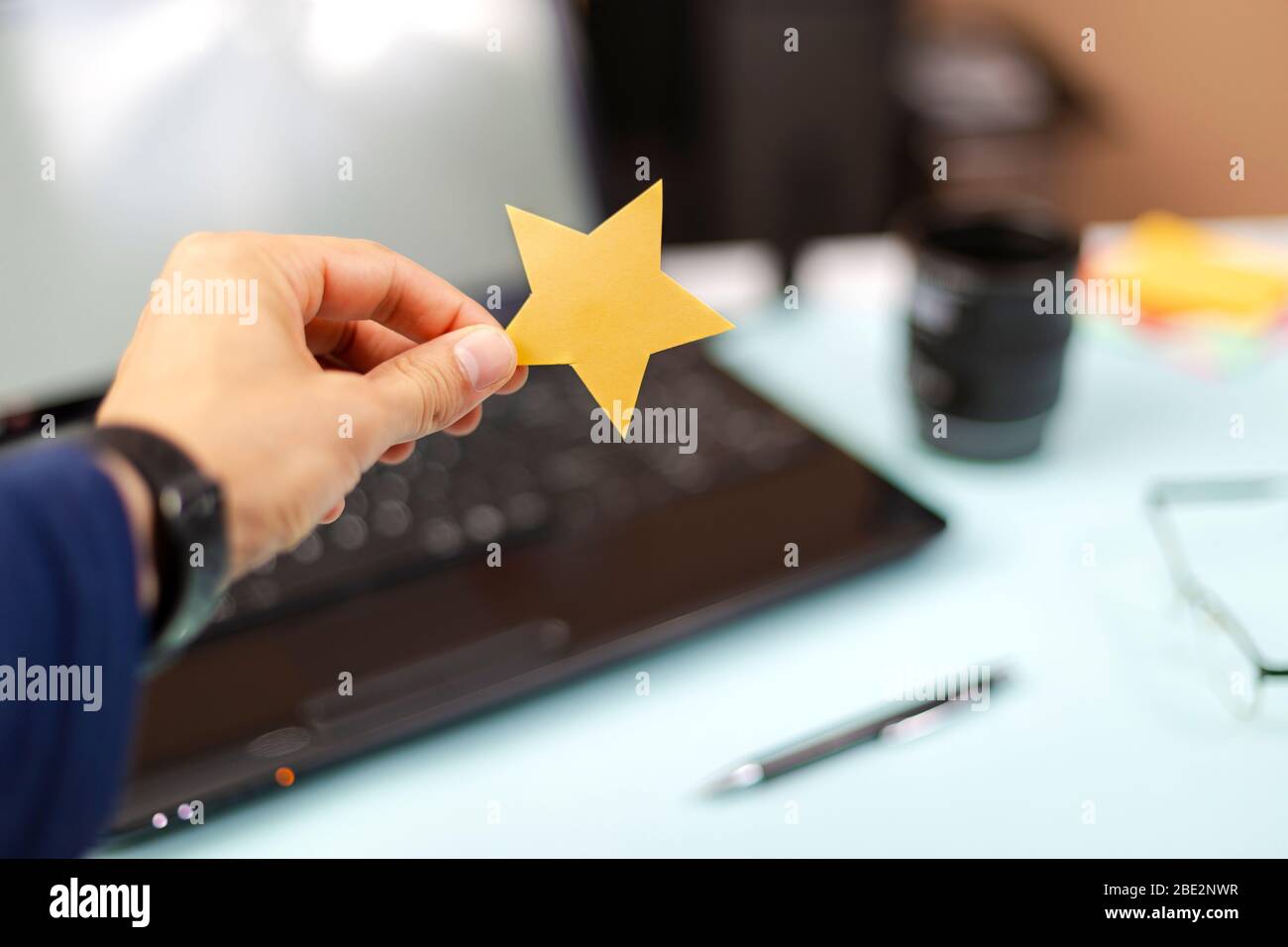Person holding a five star excellent rating, place for text. Feedback return, Customer Experience Concept Stock Photo