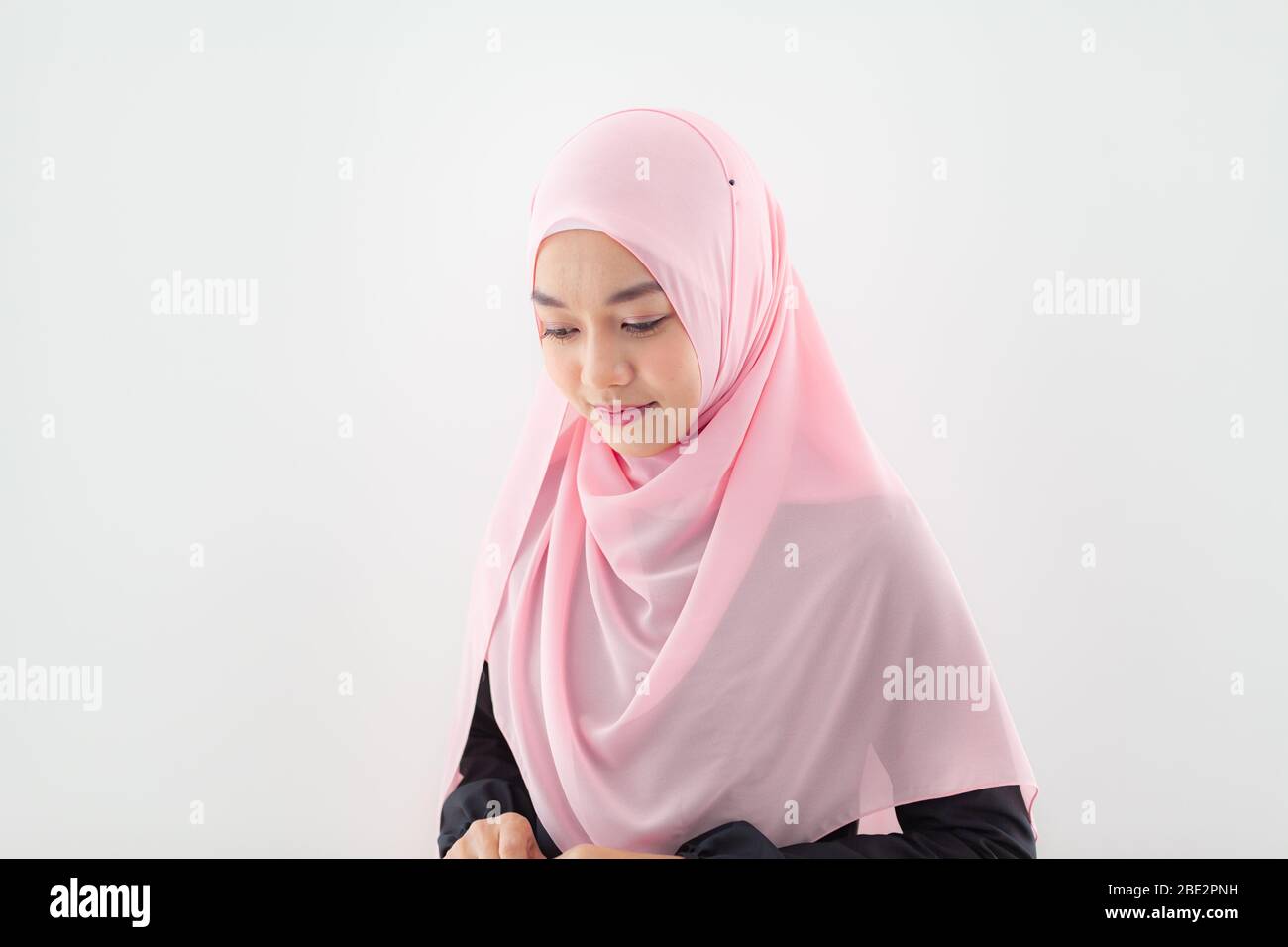 Close up Portrait of a beautiful Muslim Asian woman in a pink hijab on ...