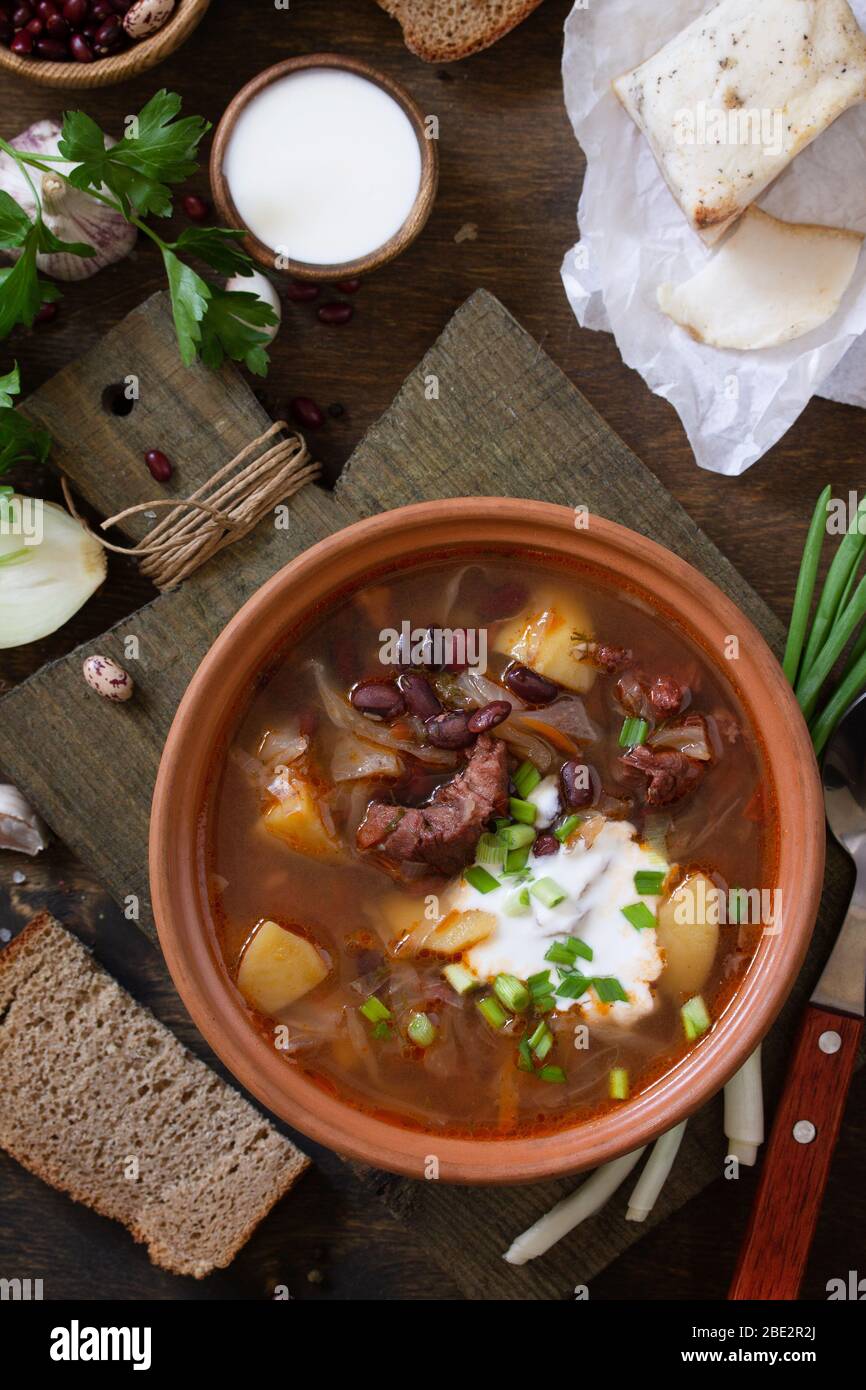 The Concept Of Healthy And Diet Food Russian Or Ukrainian Cuisine Soup With Meat And Beans Or Borsch Served With Sour Cream On A Rustic Wooden Table Stock Photo Alamy