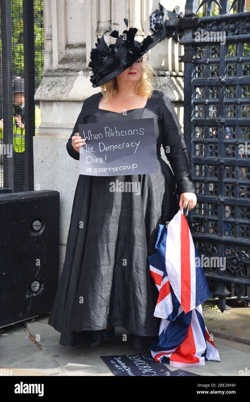 Woman standing with a protesting poster in London Stock Photo