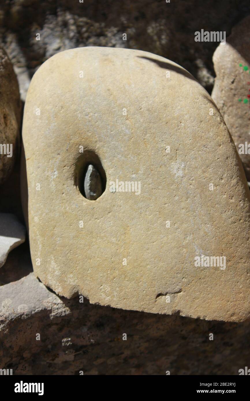 Stone, with a hole, with a pebble in the hole Stock Photo