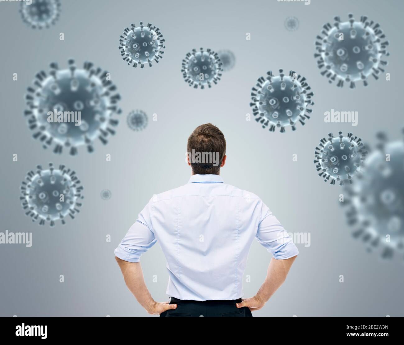 rear view of young  caucasian man looking at 3D coronavirus concept for combating COVID-19 global pandemic Stock Photo