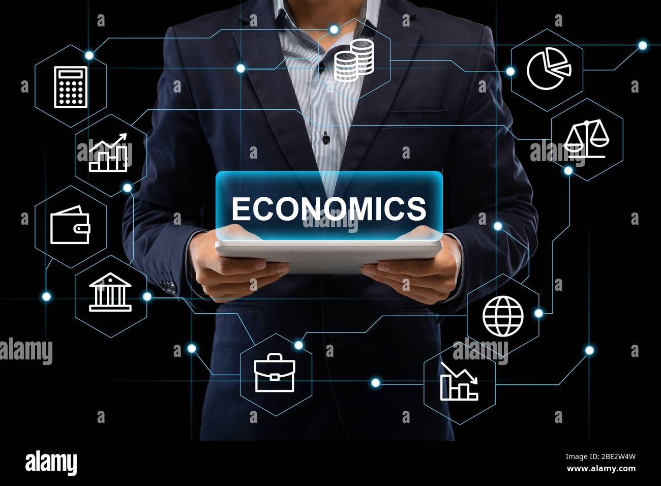 Mans hands holding tablet with inscription economics Stock Photo