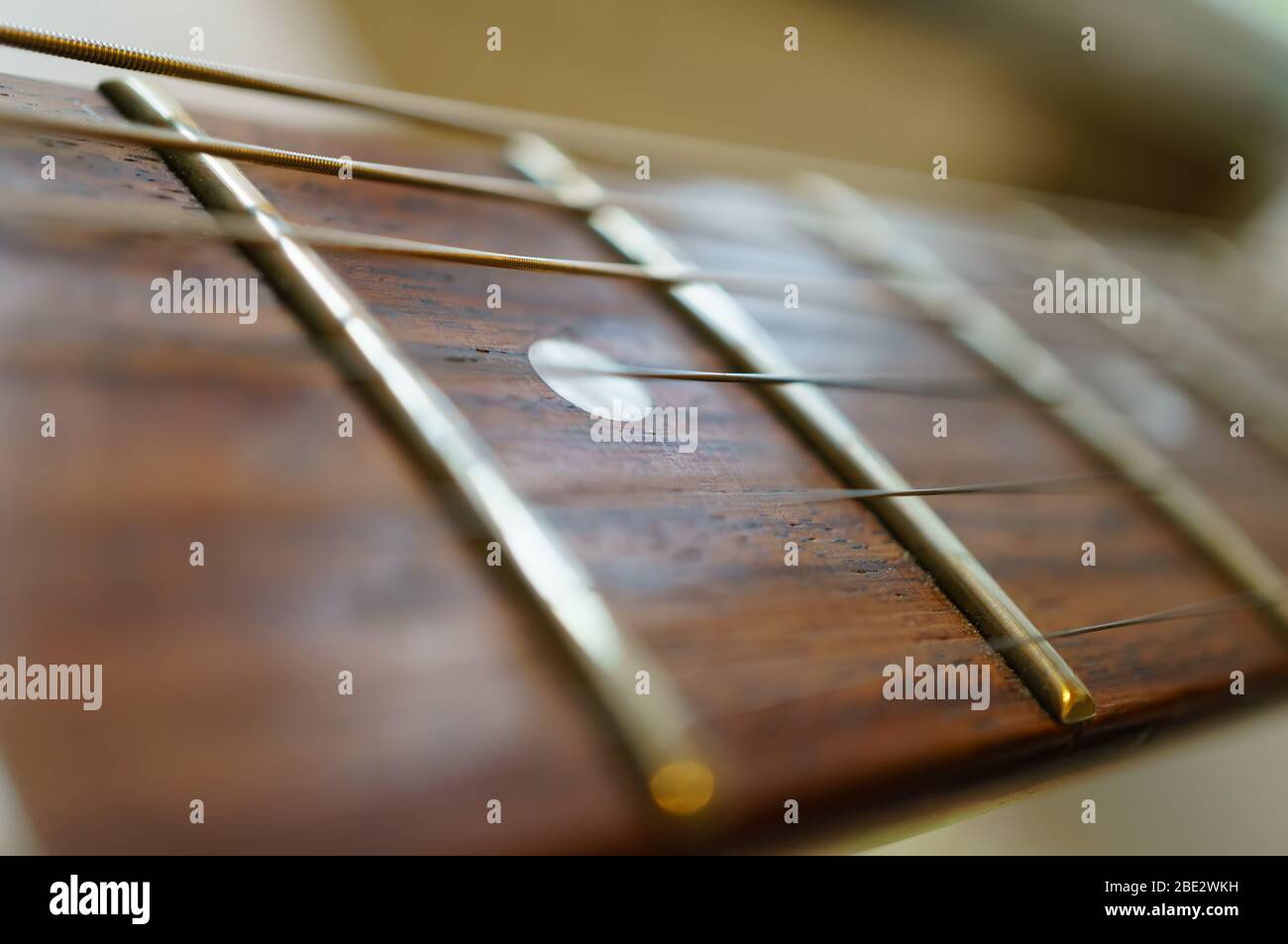 Fragment of a guitar fretboard with strings. Soft focus, shallow depth of field Stock Photo