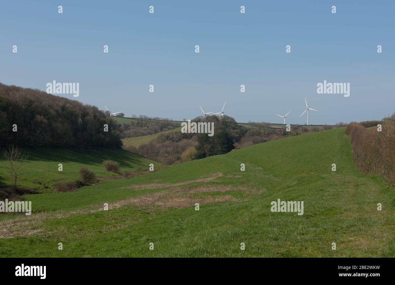Gently Rolling Landscape with Wind Turbines in the Background Near the