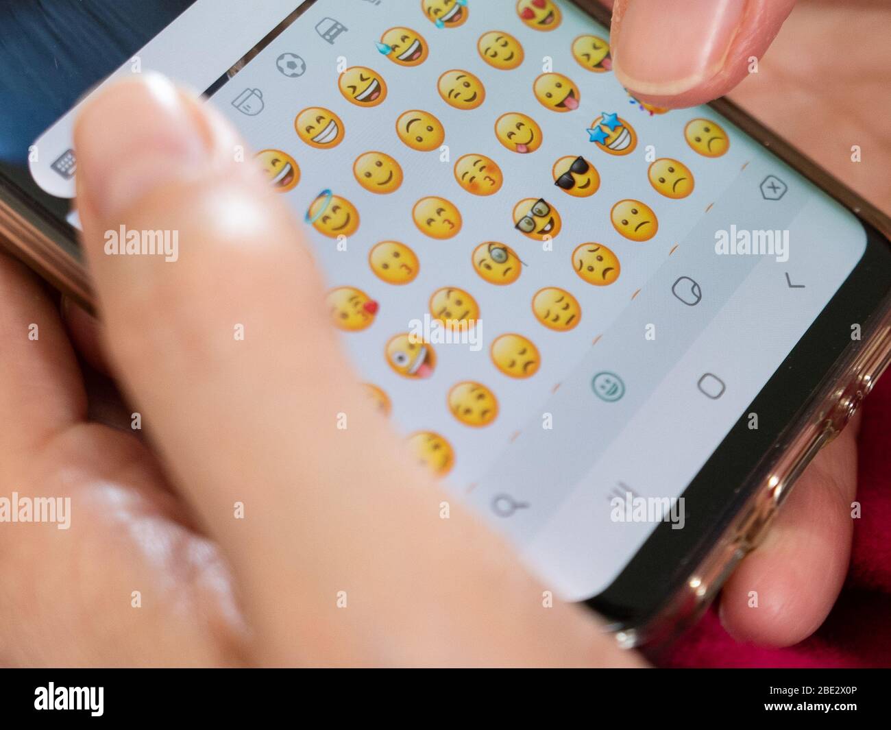 woman sends funny emoticons on an instant messaging application Stock Photo