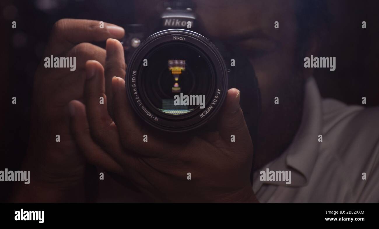 A Photographer clicking picture with his DSLR Camera Stock Photo Alamy