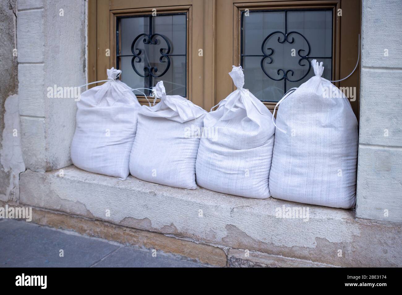 Sandbags stacked in front of doors to protect against flooding of water