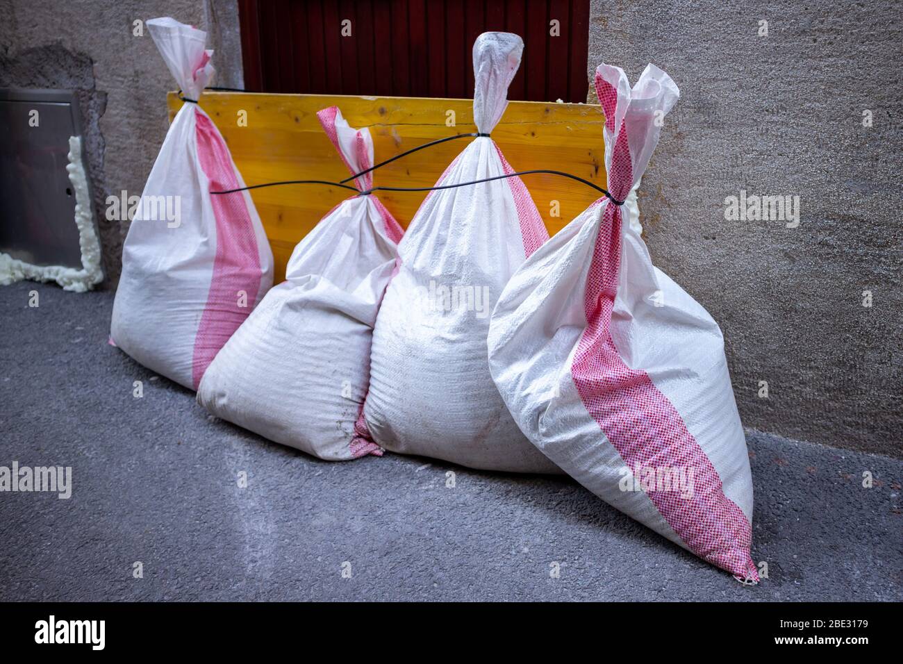Sandbags stacked in front of doors to protect against flooding of water