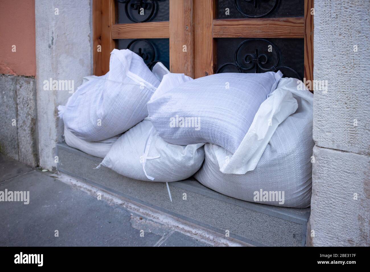 Sandbags stacked in front of doors to protect against flooding of water