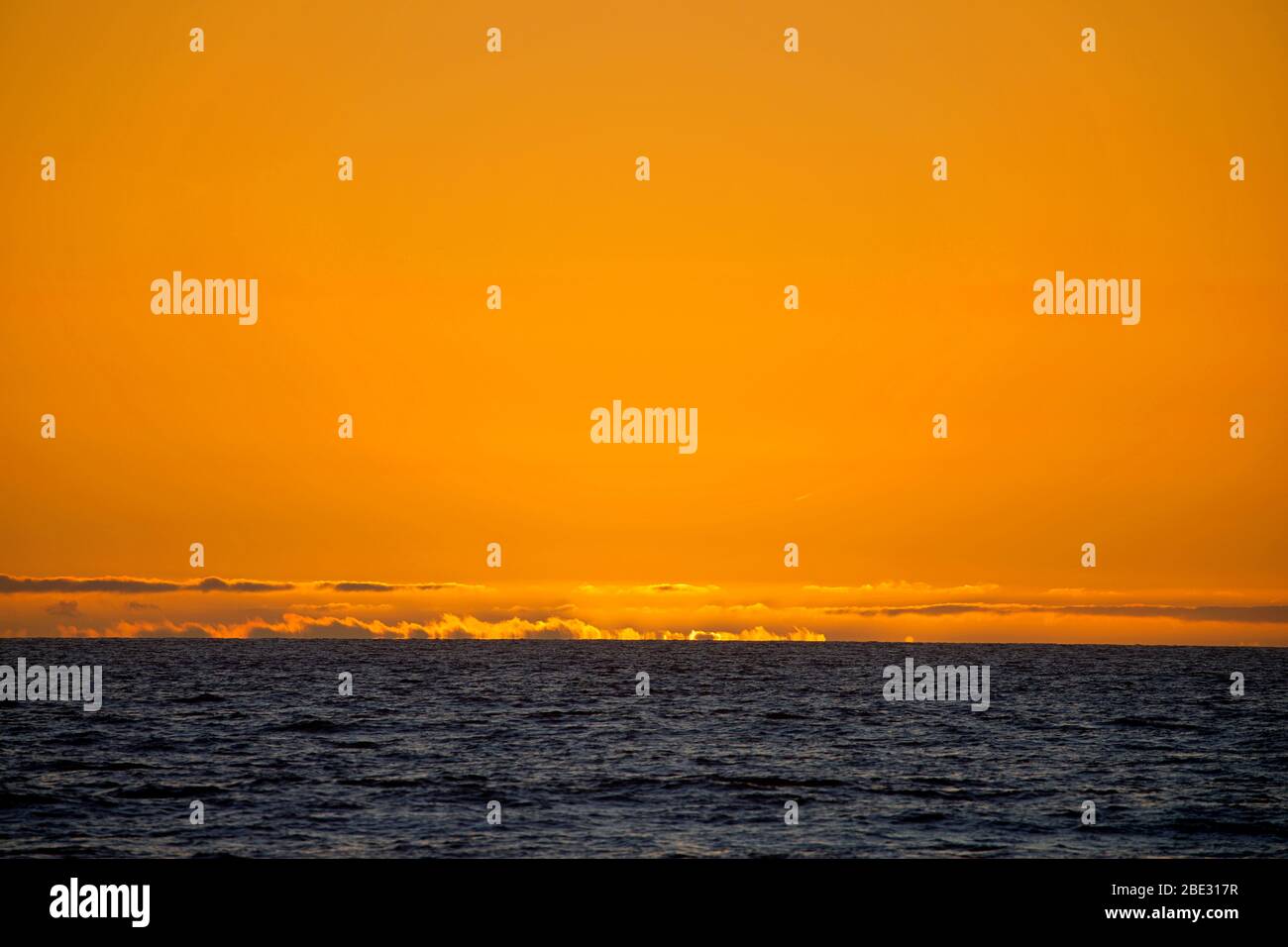 glooming sun rising over the sea Stock Photo