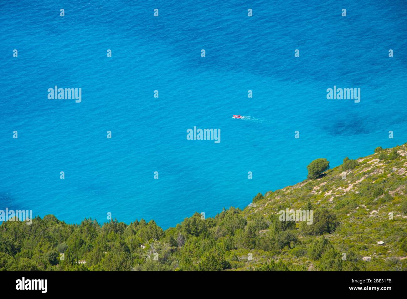 A boat is sailing into the endless ocean with crystal clear turquoise