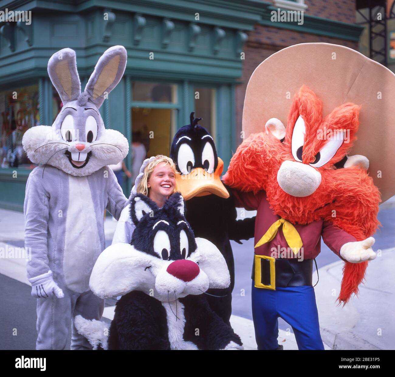 Young girl with Looney Tunes characters at Warner Bros Movie World Theme Park, Oxenford, City of Gold Coast, Queensland, Australia Stock Photo