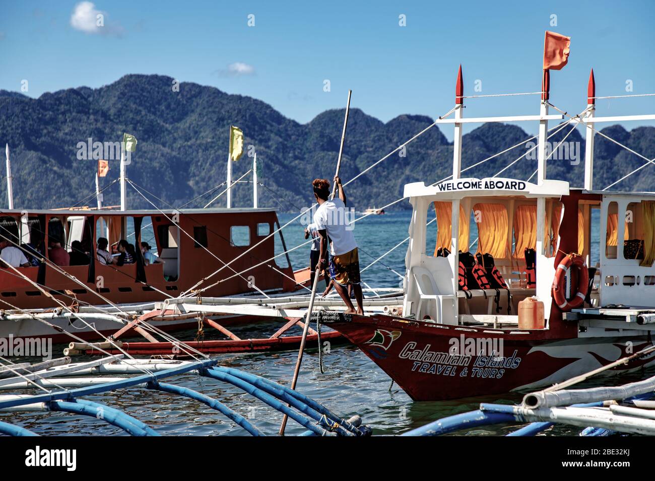 Local filipino man preparing to sail in the port of Coron Stock Photo