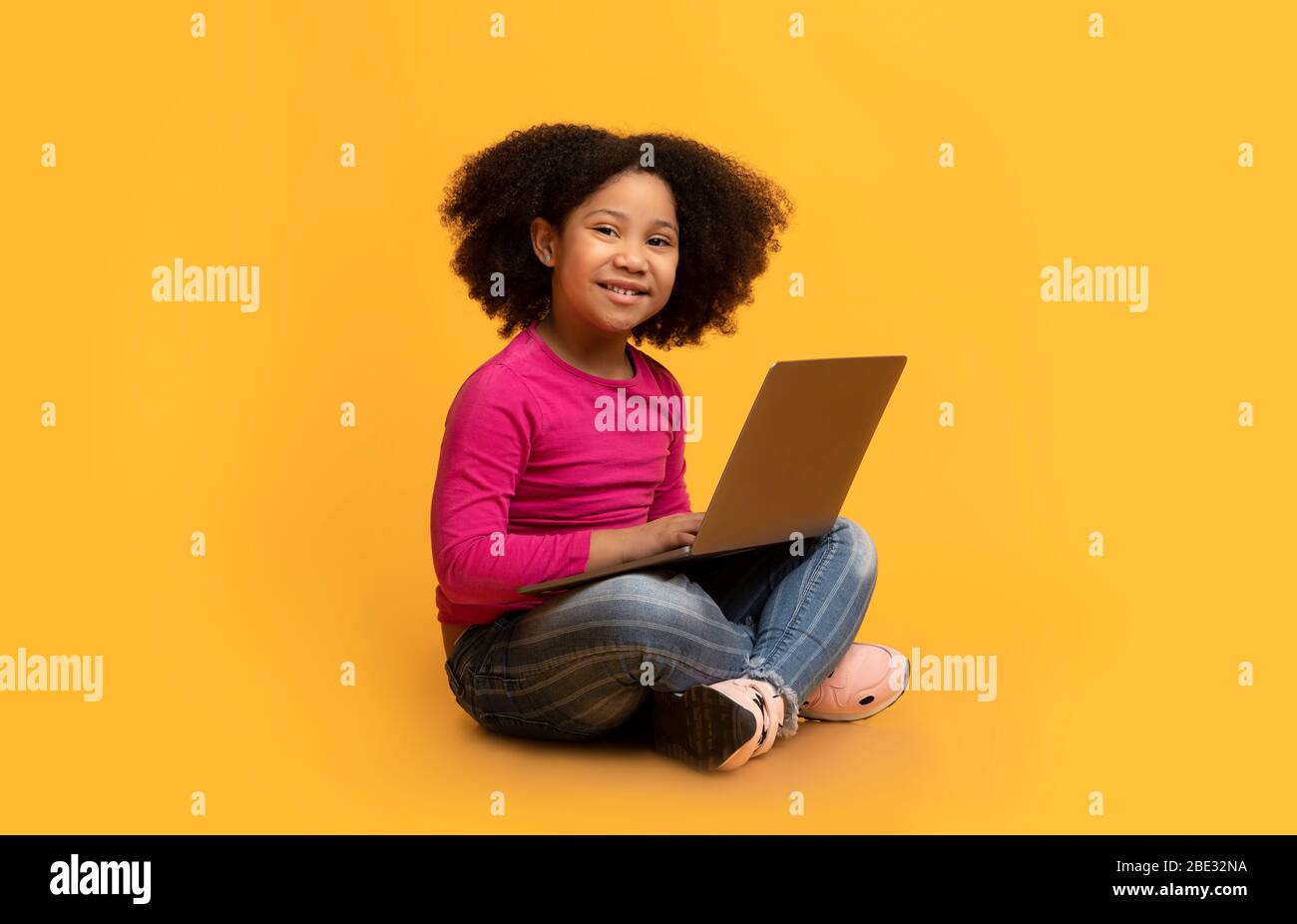 Online Education Concept. Adorable Little Girl Sitting On Floor With ...