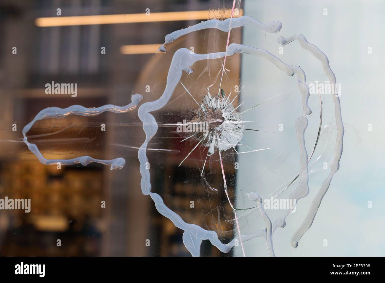 Broken window glass of a store located in downtown Zürich, Switzerland. Crushed and shattered glass, hopefully the insurance will cover the damage. Stock Photo