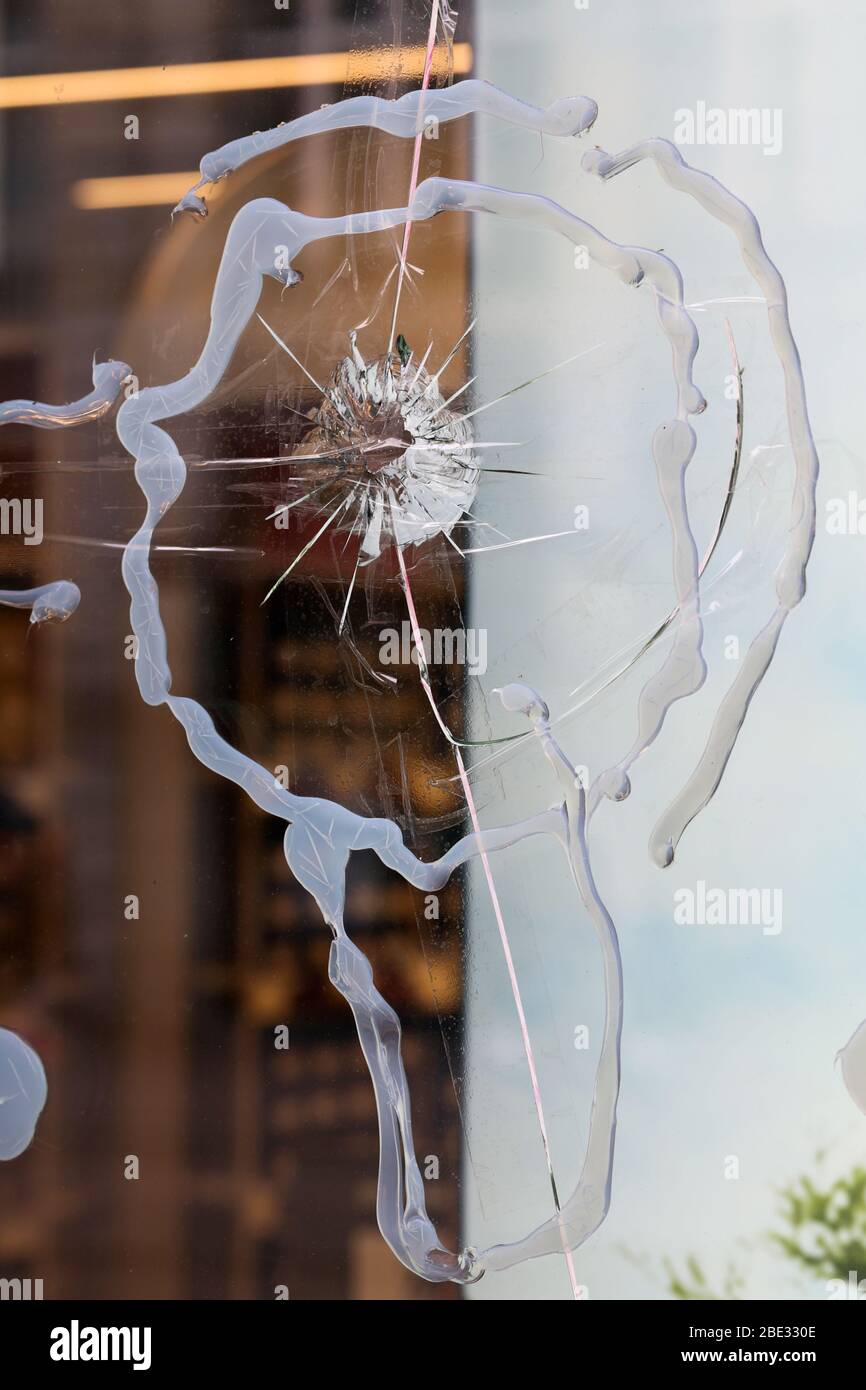 Broken window glass of a store located in downtown Zürich, Switzerland. Crushed and shattered glass, hopefully the insurance will cover the damage. Stock Photo