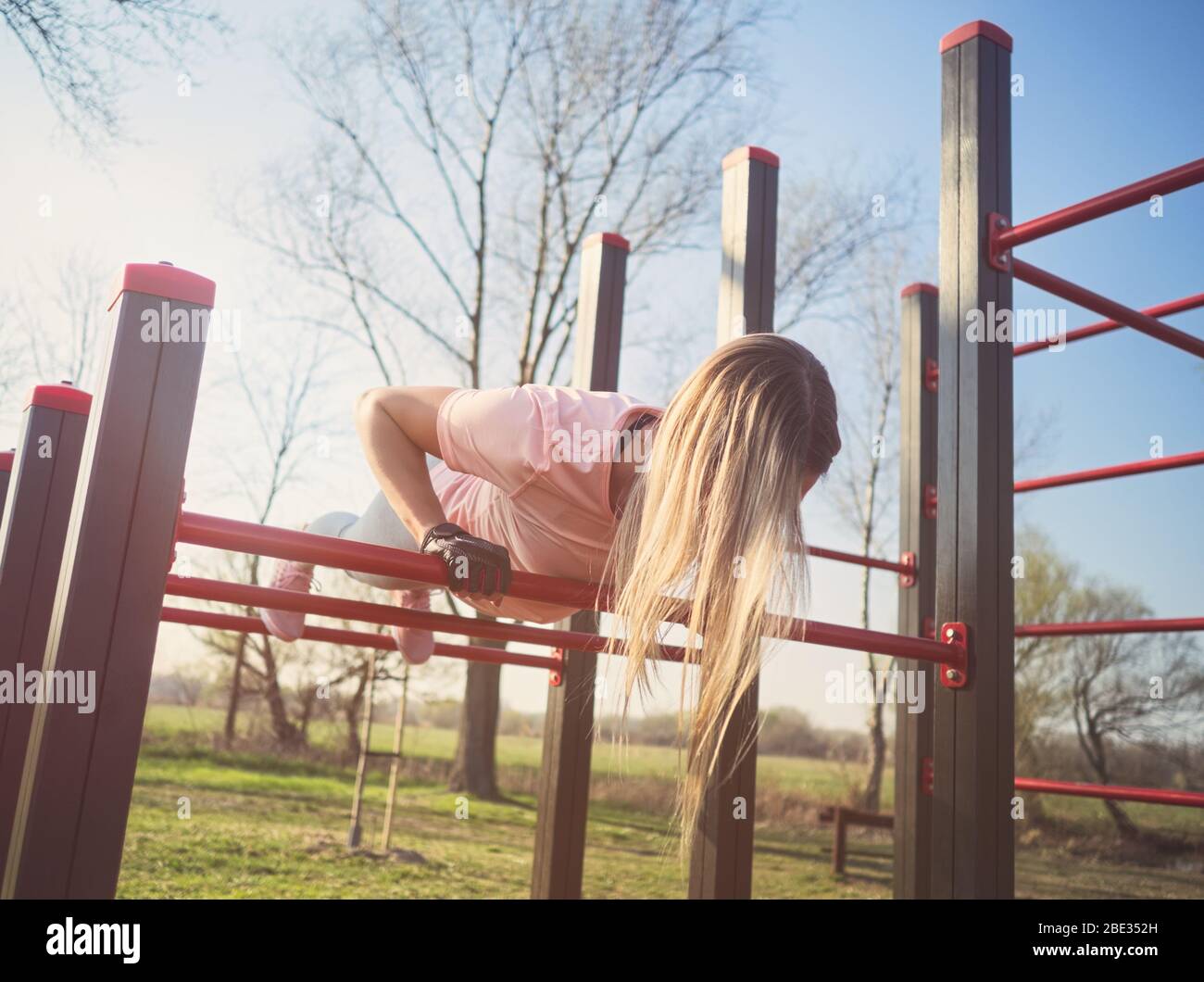 Young Athletic Woman Doing Push Ups on Monkey Bars in the Park Stock Photo Alamy