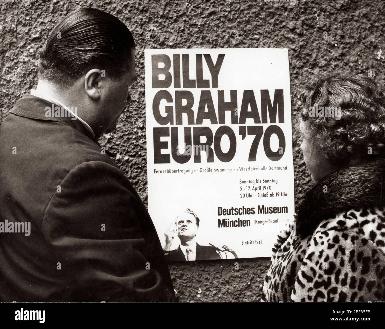 Apr. 2, 1970 - London, England, U.K. - BILLY GRAHAM, born William Franklin Graham, Jr. on November 7, 1918, is an evangelical Christian reverend.  He gained celebrity status by broadcasting his sermons on radio and television. PICTURED: Citizens read poster for Billy Graham's European tour. Stock Photo