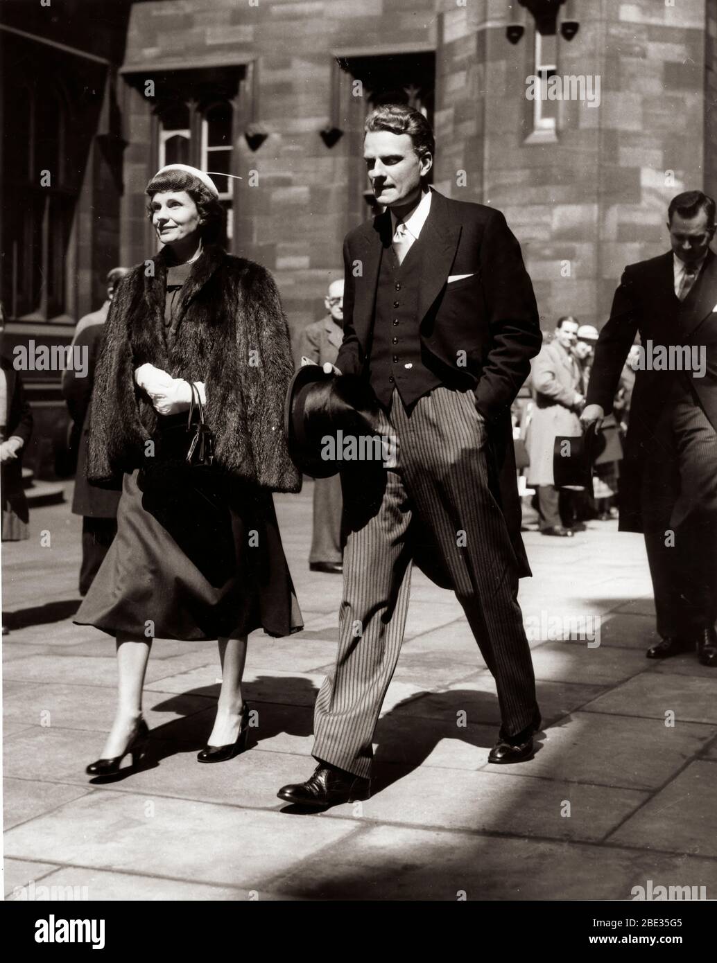 Oct. 2, 1960 - London, England, U.K. - BILLY GRAHAM, born William Franklin Graham, Jr. on November 7, 1918, is an evangelical Christian reverend.  He gained celebrity status by broadcasting his sermons on radio and television. PICTURED: Reverend Billy Graham walking with wife RUTH GRAHAM. Stock Photo