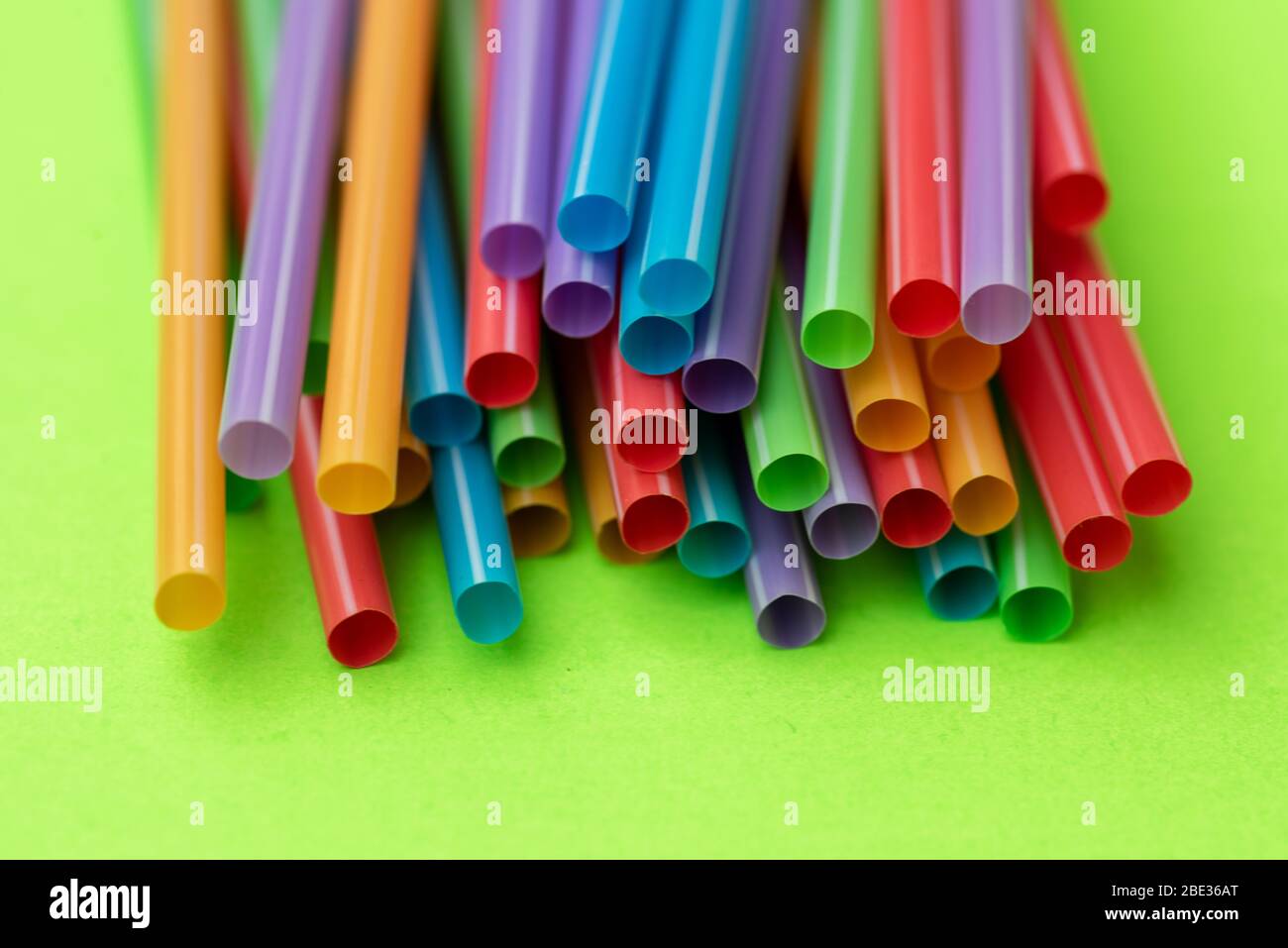Plastic straws against colorful background Stock Photo