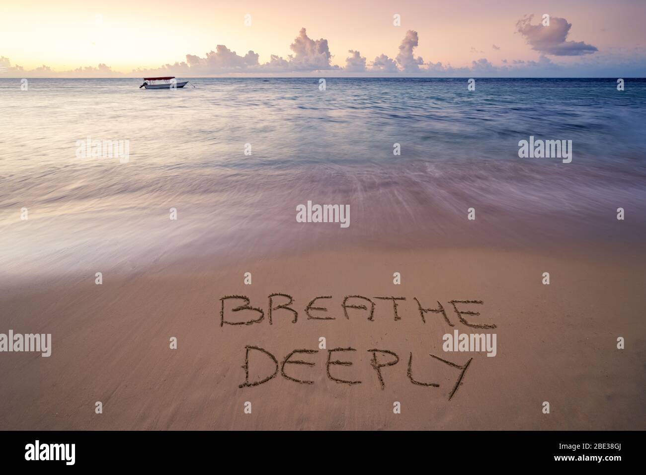 Handwritten Breathe deeply on sandy beach at sunset,relax and summer concept,Dominican republic beach. Stock Photo
