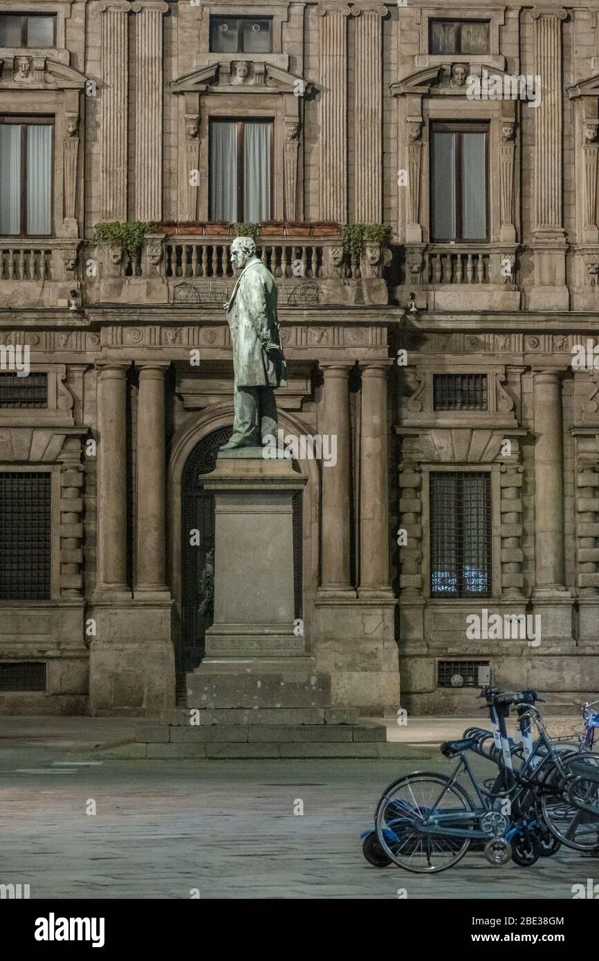 Night view of the monument dedicated to Alessandro Manzoni in San Fedele sq., during the COVID-19 lockdown.1883, sculptor Francesco Barzaghi.15MAR2020 Stock Photo