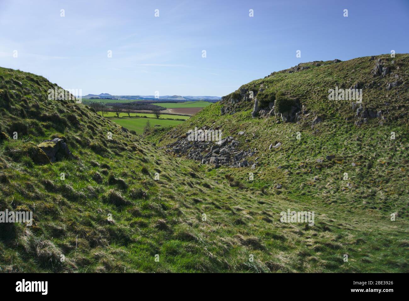 View through a cleft in two small hills towards farmland in Berwickshire, Scottish Borders, UK Stock Photo