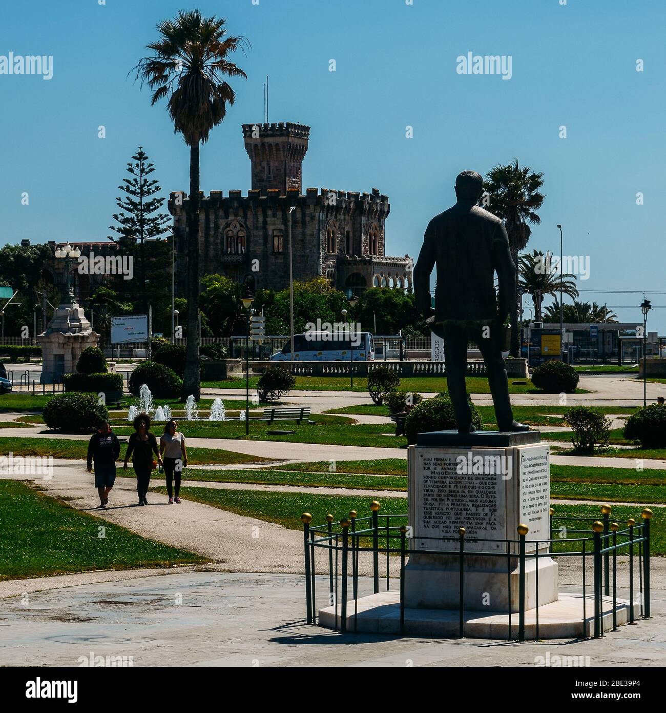 Estoril, Portugal - April 11, 2020: Statue of Fausto Cardoso and Baronial Estoril Castle in background overlooking the ocean Stock Photo