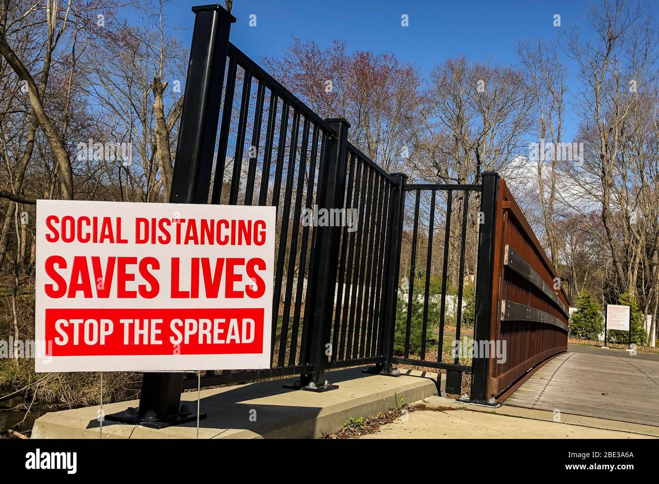 Social Distancing Sign posted in a park in Connecticut United States. Stock Photo