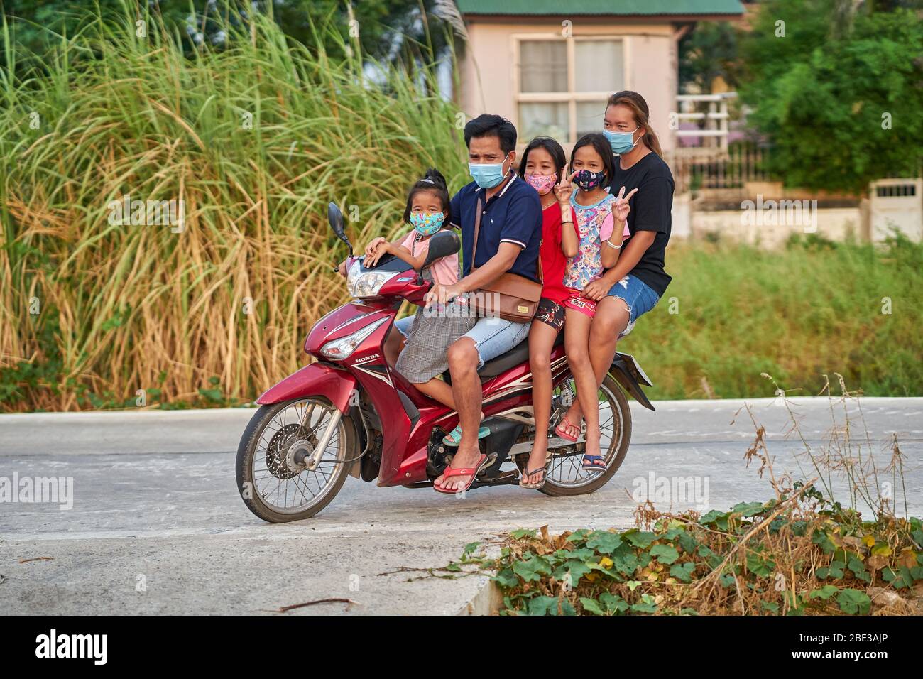Thai family on motorcycle hi-res stock photography and ...