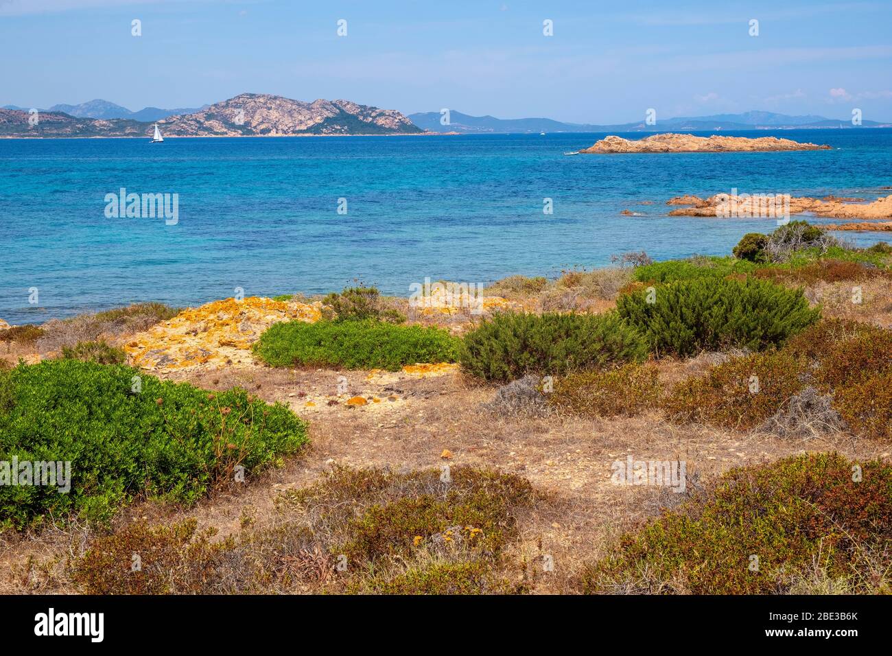 Panoramic view of Spalmatore di Terra peninsula of Marine Protected Area reserve with seashore rocks of Isola Tavolara island on Tyrrhenian Sea Stock Photo
