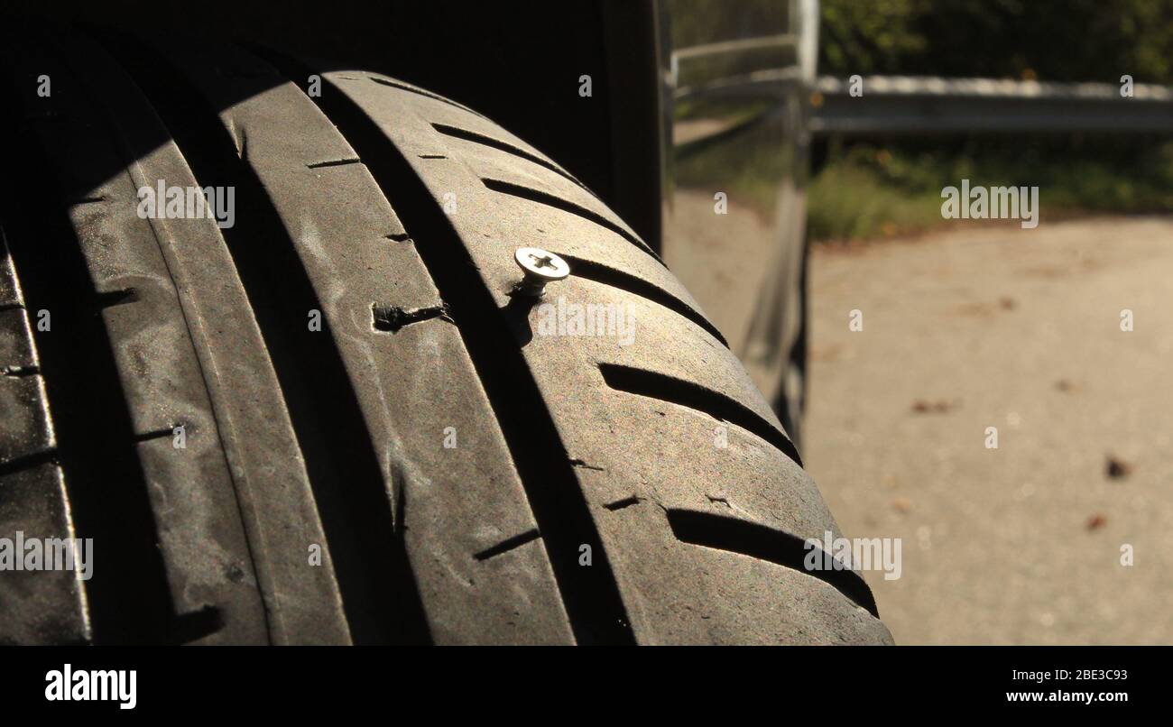 Metal Screw Sticking Out From Car Tire Stock Photo Alamy