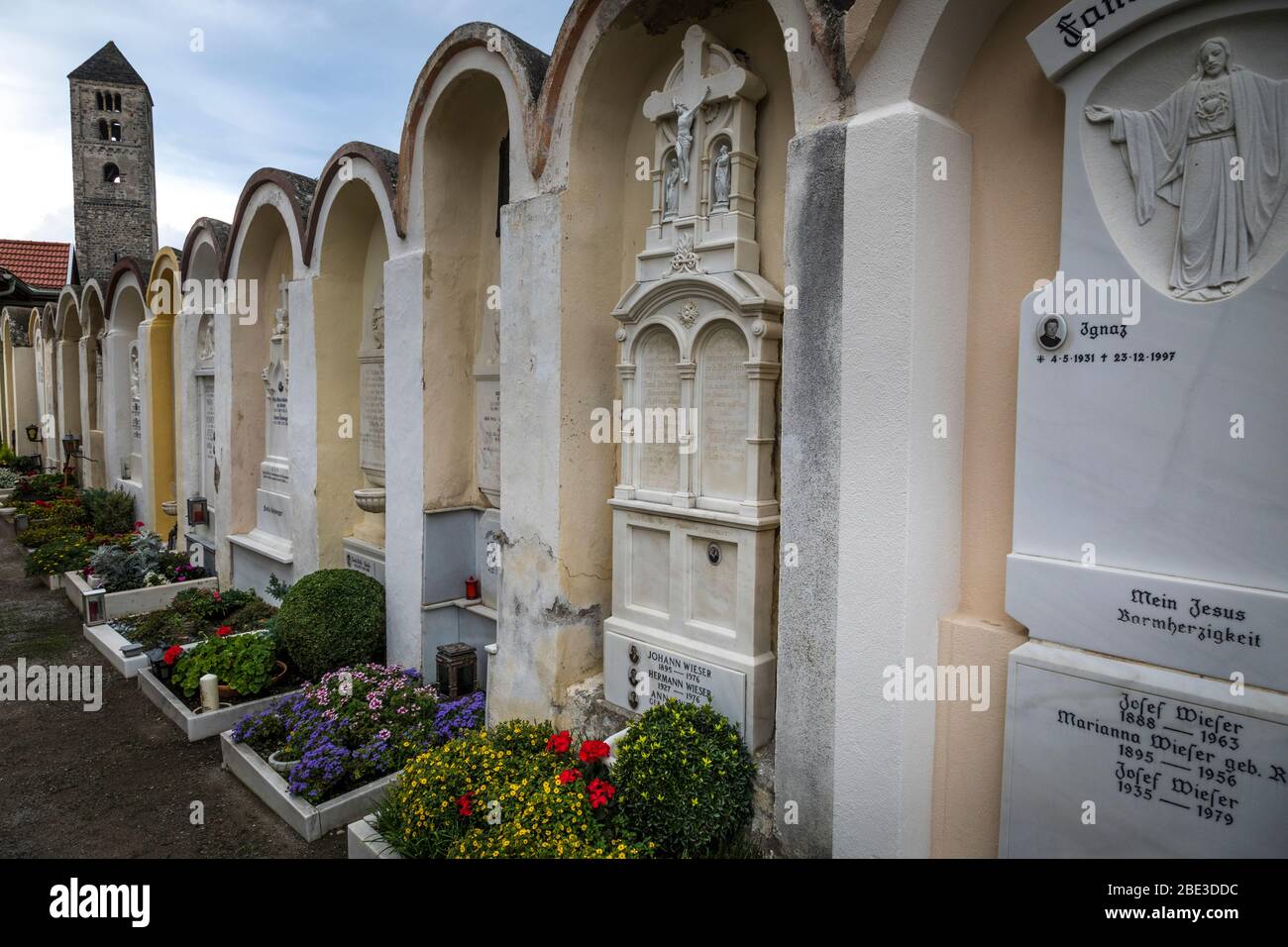 A row of ornate headstones and memorials in a cemetery in Malles Venosta (Mals Venosta), Italy Stock Photo