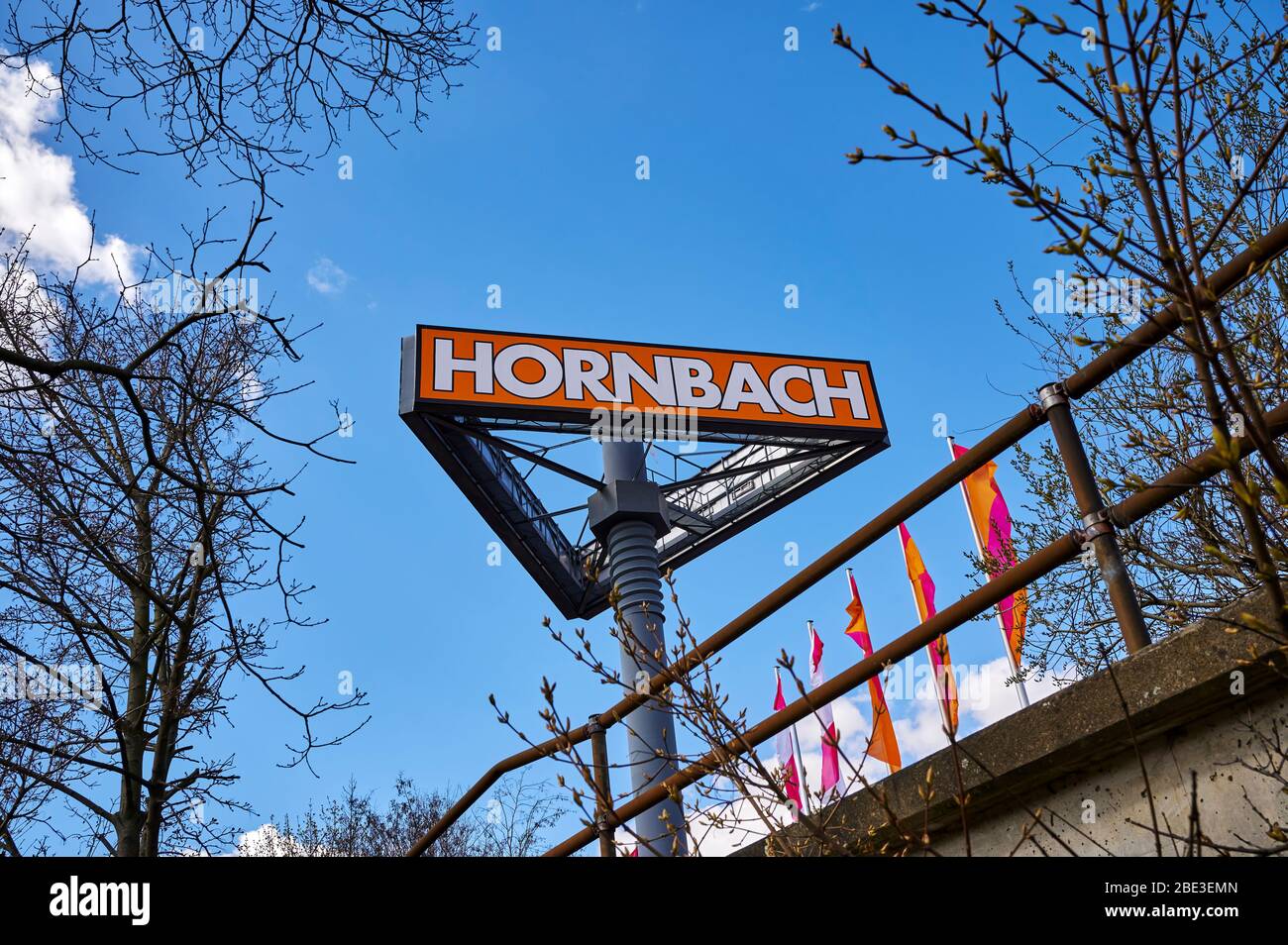 Berlin, Germany - April 4, 2020: Large sign for a hardware store in Germany with a mast that is designed like an oversized screw. Stock Photo