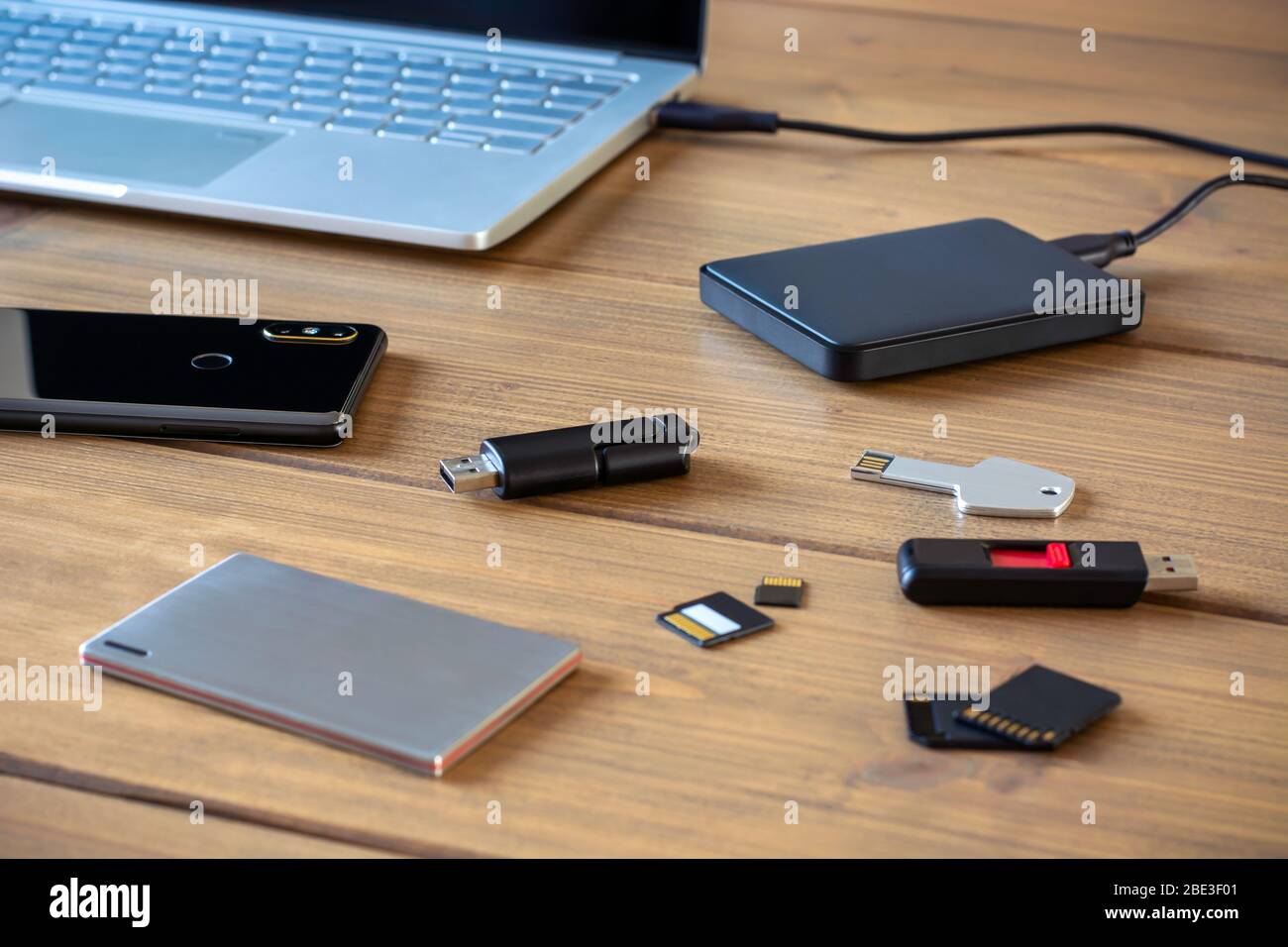 Various digital data storage devices. Usb sticks, external hard drive, SD cards, mini and micro SD cards, laptop and smartphone Stock Photo