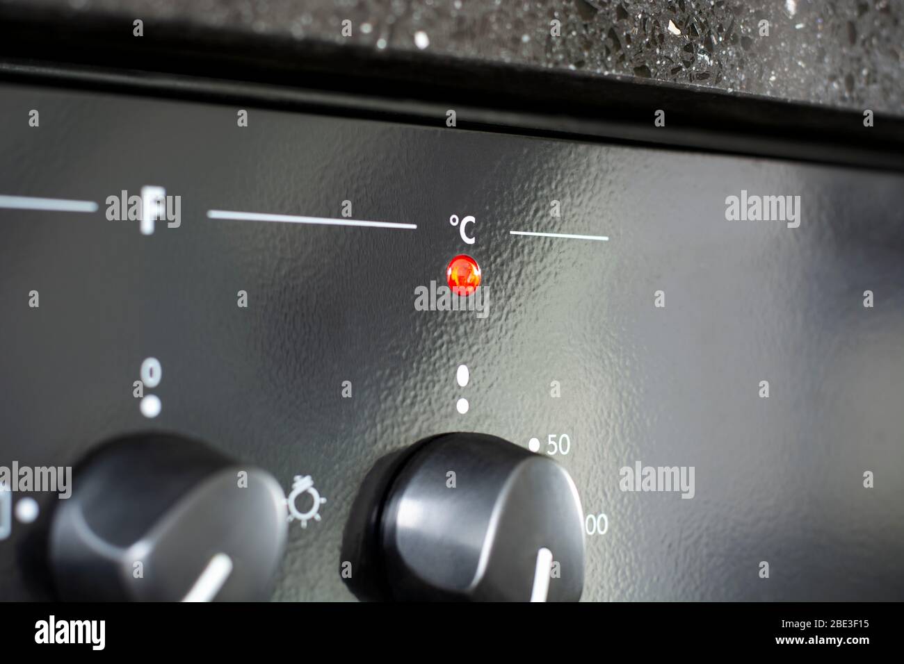 Celsius with red indicator light. Heating up the oven in kitchen Stock Photo