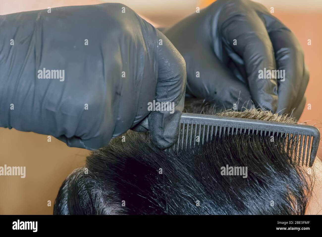 Hair dye scalp applied by hairdresser with gloves at home hires stock