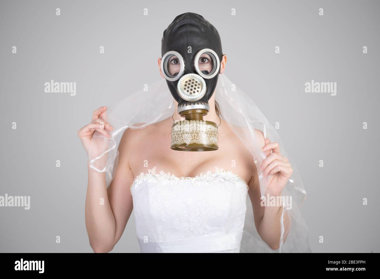 cyberpunk Bride in veil dress and protective gas mask and veil posing.  wedding Style spring-summer 2020 Stock Photo - Alamy