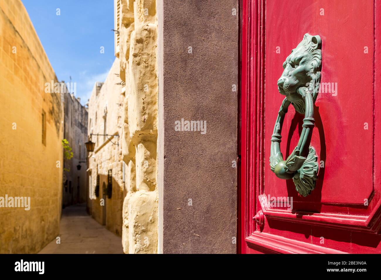 Door knocker on red door, walled city of Mdina, Malta Stock Photo