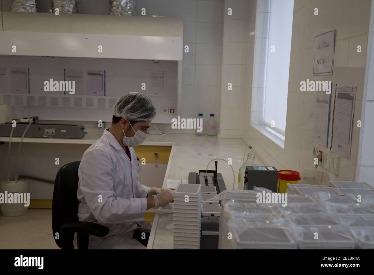 Karaj, Alborz, Iran. 11th Apr, 2020. Iranian medical staff work on the production of COVID-19 test kits at the Pishtaz-Teb knowledge-based medical company just outside the city of Karaj, in the northern Alborz Province. Iran launched the production line of serology-based test kits that can discover whether a person has ever been exposed to the novel coronavirus or suffered from the COVID-19 disease and recovered or not. Iran is one of the most affected by pandemic COVID-19 disease caused by the SARS-CoV-2 coronavirus. Credit: Rouzbeh Fouladi/ZUMA Wire/Alamy Live News Stock Photo