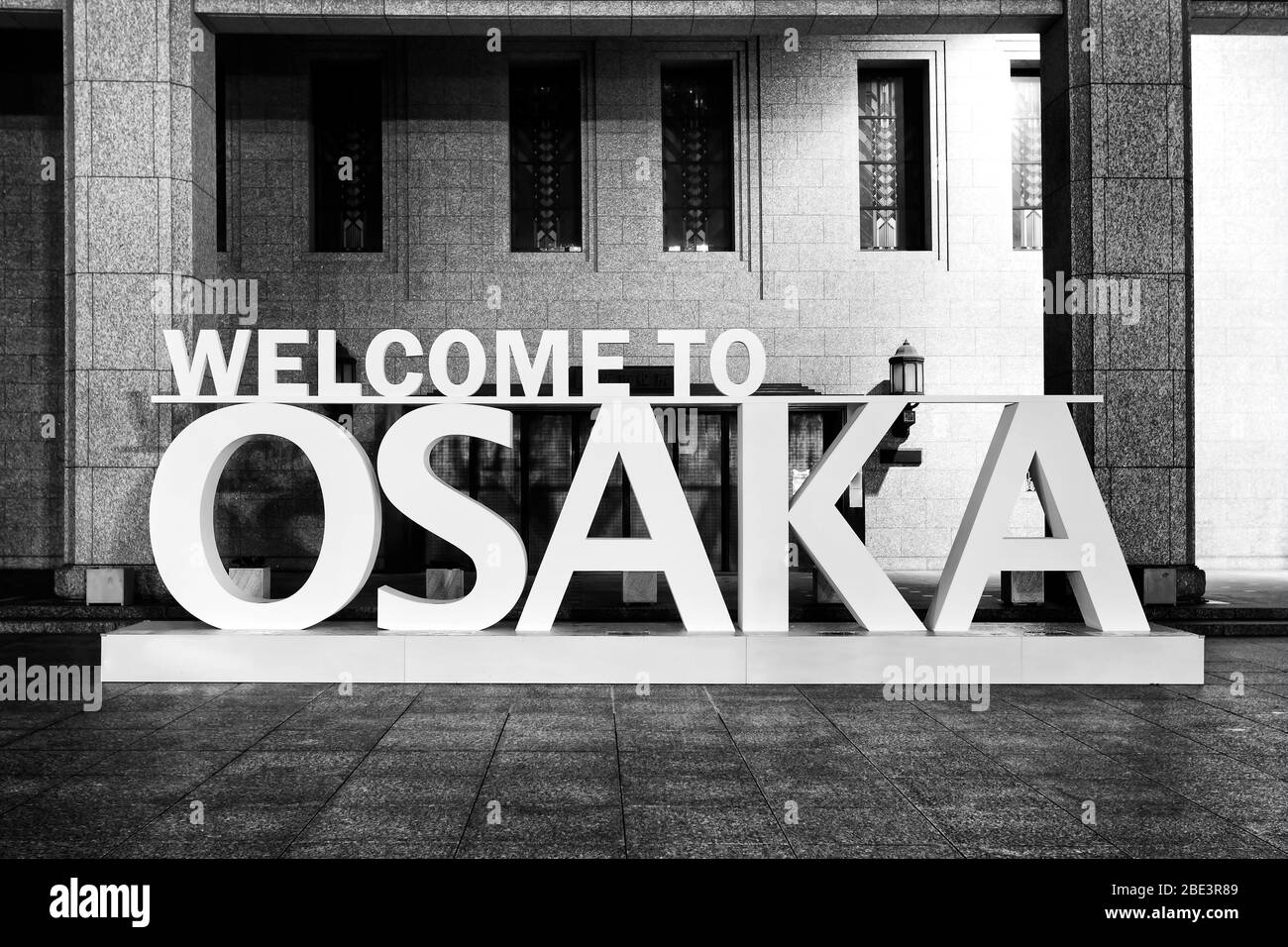 Colourless black-white impression of welcome to Osaka sign at the public building of the Town Hall in Osaka city, Japan. Stock Photo