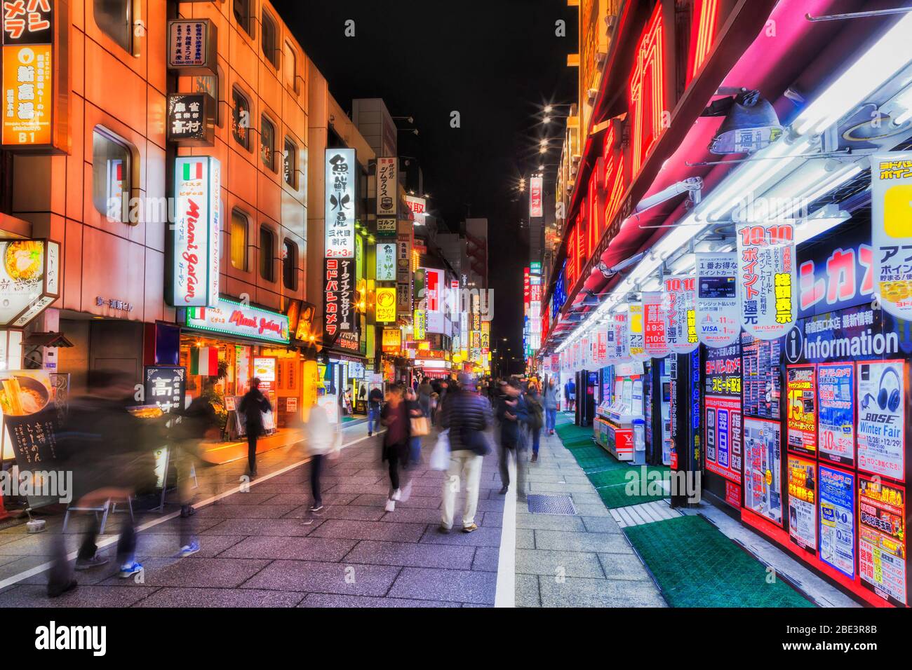 Japan, Tokyo, 31 Dec 2019: Busy shopping street in Shinjuku Kabuki-cho district of Japanese capital at night with bright ads and lights. Stock Photo
