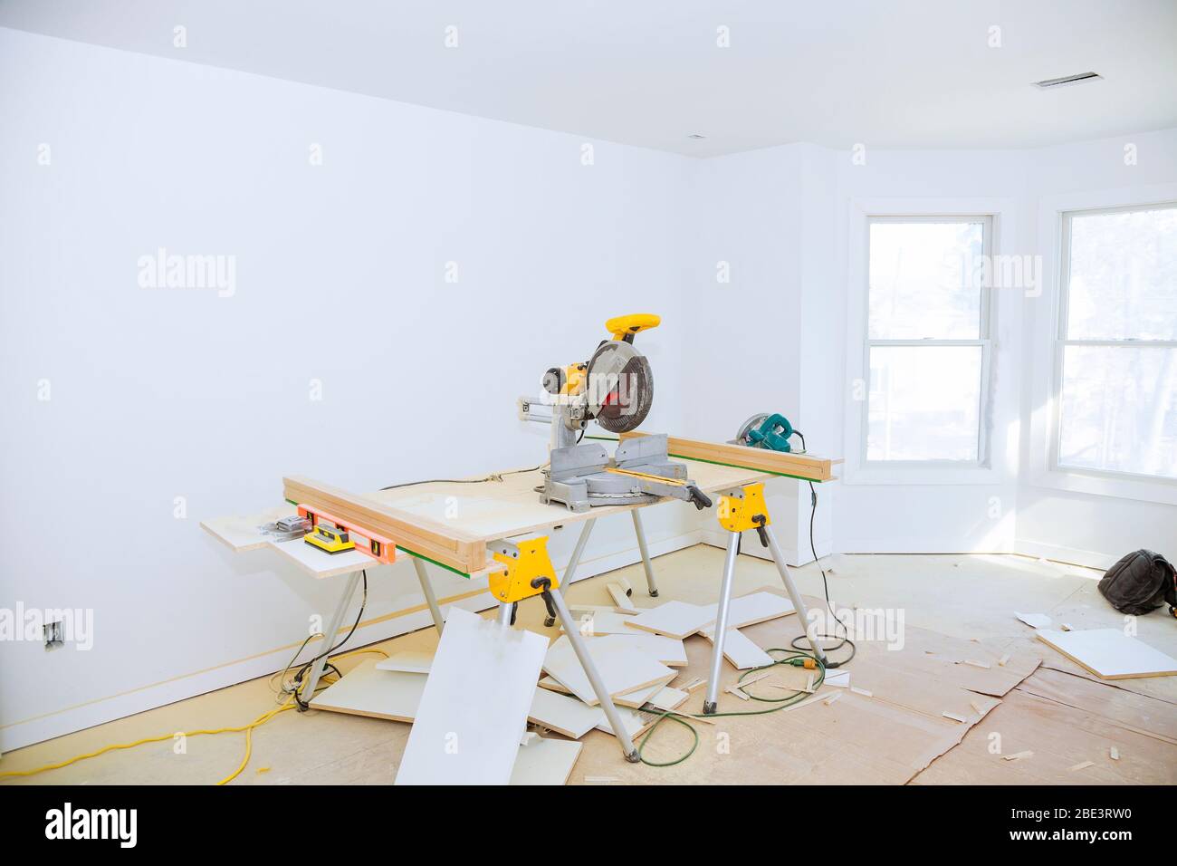 Cutting circular saw cut a piece of wood laminated shelves in apartment